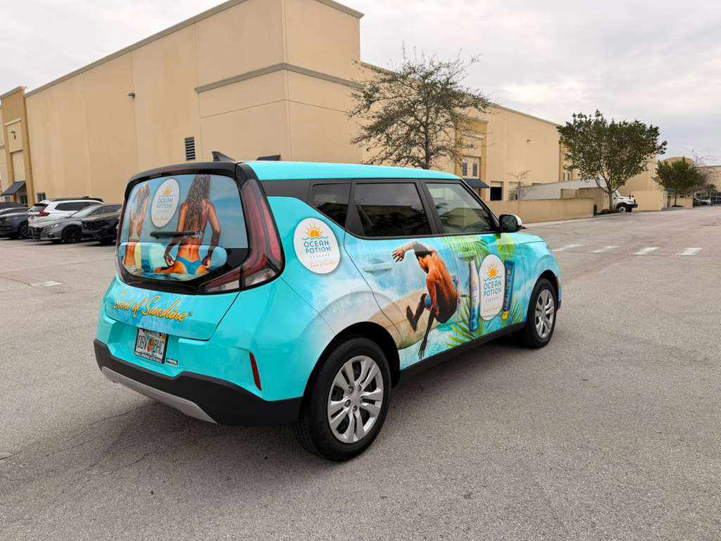 Promotional turquoise SUV wrapped with Ocean Potion sunscreen graphics parked in a lot, showing brand logos on the sides and rear