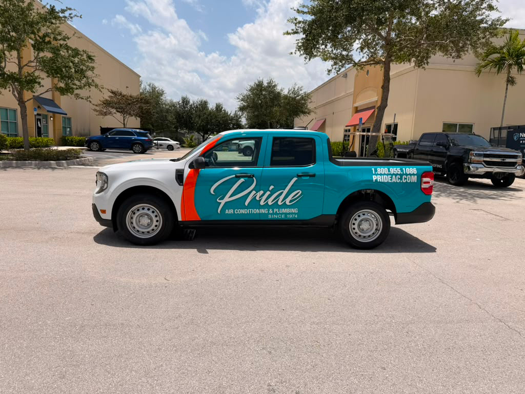 Teal Pride air conditioning truck parked in a sunny lot with company logo on the side and contact info visible