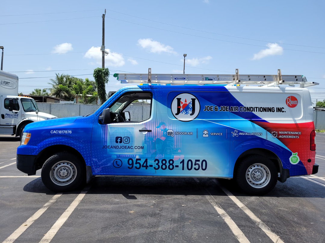 Company van for Joe & Joe Air Conditioning Inc., blue promotional vehicle with ladder rack and contact number 954-388-1050 on the side