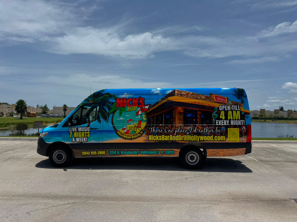 Colorful Nick's Bar & Grill promotional van with a beach scene, advertising late-night hours and live music.