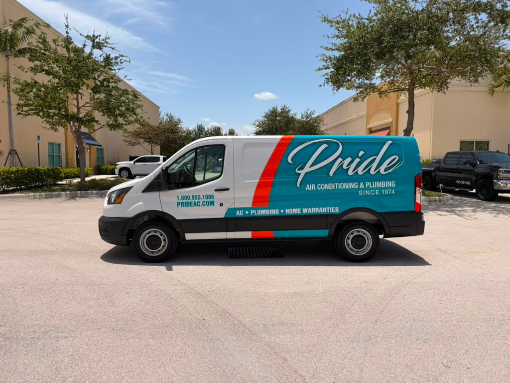 White and teal Pride van for air conditioning and plumbing parked in a lot; side shows the Pride logo and 'Since 1974'.