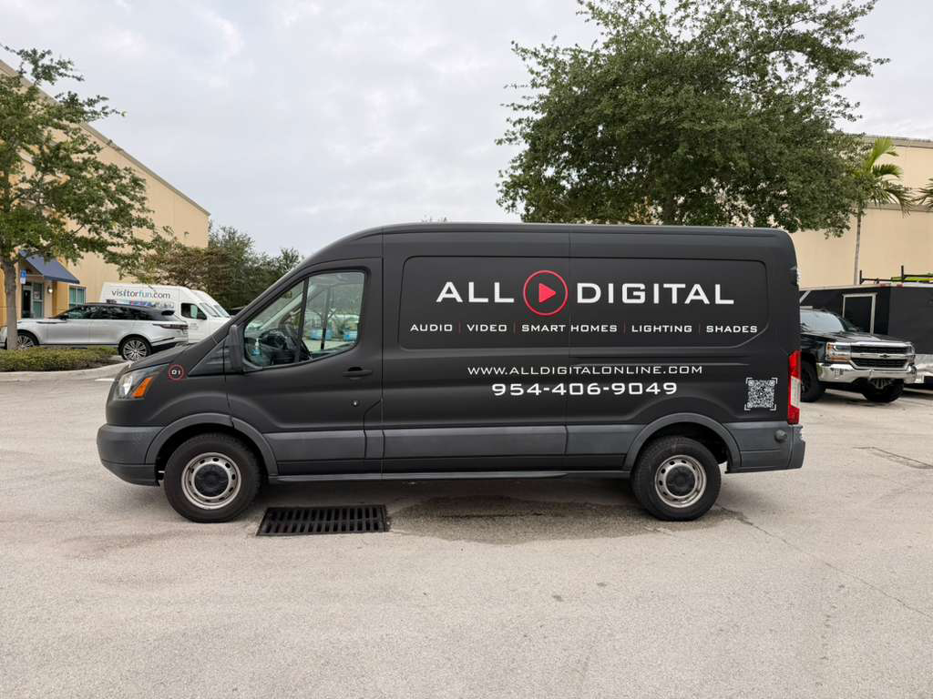 Dark gray All Digital van parked in a lot, side panel shows logo, services, and contact info (www.alldigitalonline.com, 954-406-9049).