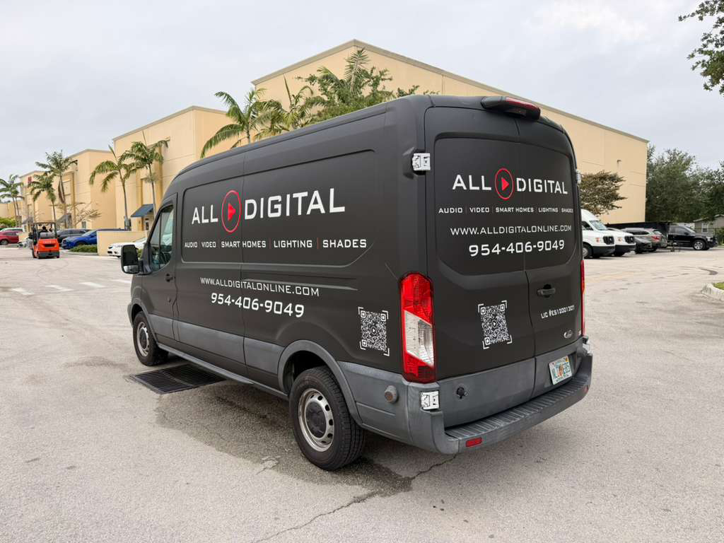 Black ALL DIGITAL service van parked in a lot with logo and contact info on the sides and rear.